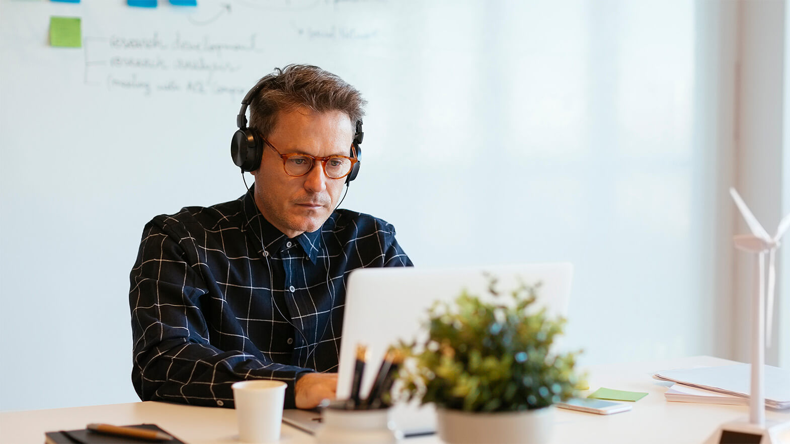 A man engaged in learning, representing personal development and growth at acrontum.